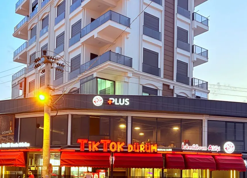 The TikTok Dürüm front with red awnings at sunset