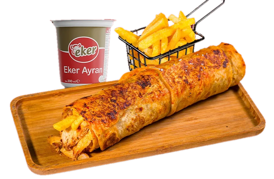 Chicken dürüm with sauce on a wooden board, with fries and ayran